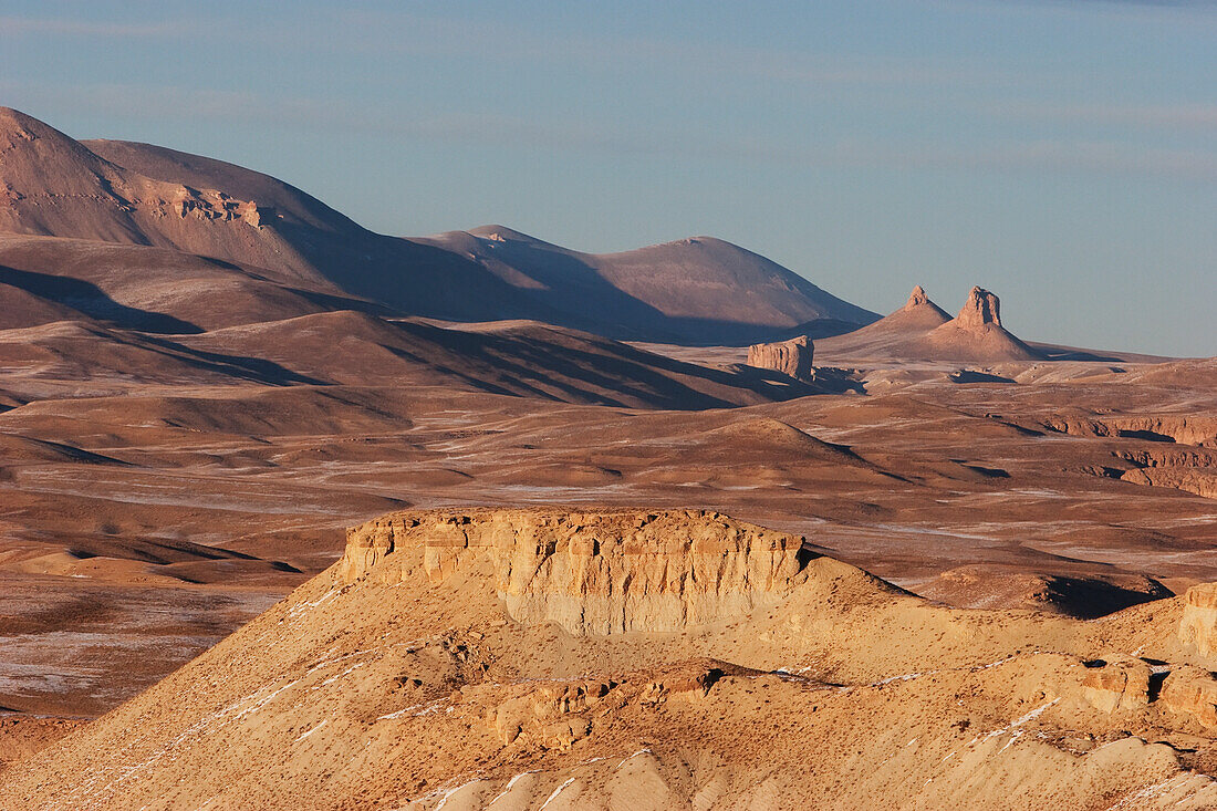 Barren rock formations on a plateau in the Band-i-Amir area lit by the late afternoon sun, Bamian Province, Afghanistan