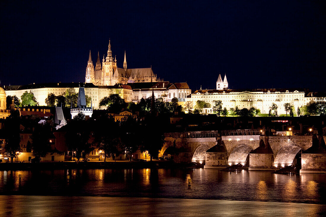 Charles Bridge and Prague Castle reflected in the Vltava river at night, Prague, Czech Republic