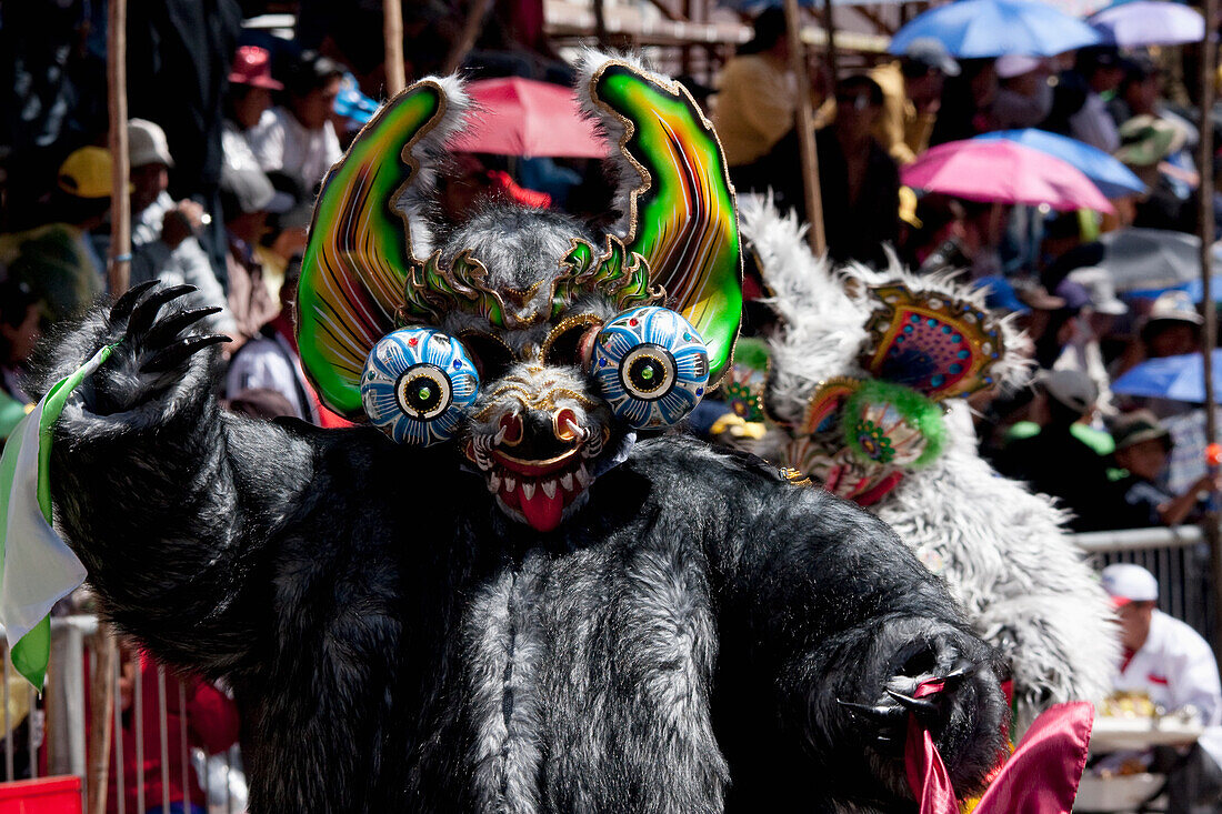 Diablada dancer wearing an elaborate devil mask and costume in the procession of the Carnaval de Oruro, Oruro, Bolivia