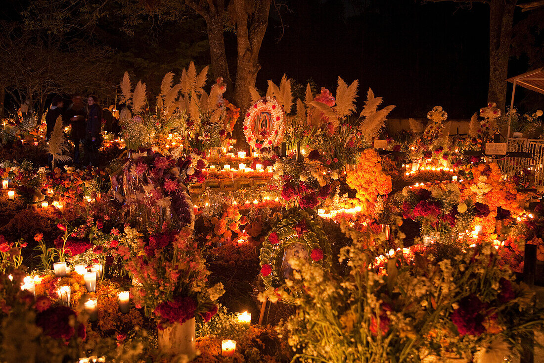 Celebration of DÃ­a de los Muertos, the Day of the Dead at the TzurumÃºtaro cemetery. People decorate the graves of their loved ones with offerings of reeds, flowers, particularly marigolds (cempoalxÃ³chitl or zempasuchil), bread of the dead (pan de muert