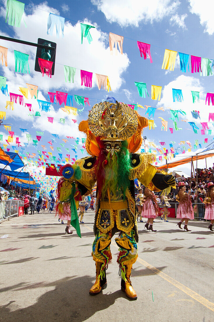 Morenada dancer wearing an elaborate mask and costume in the procession of the Carnaval de Oruro, Oruro, Bolivia