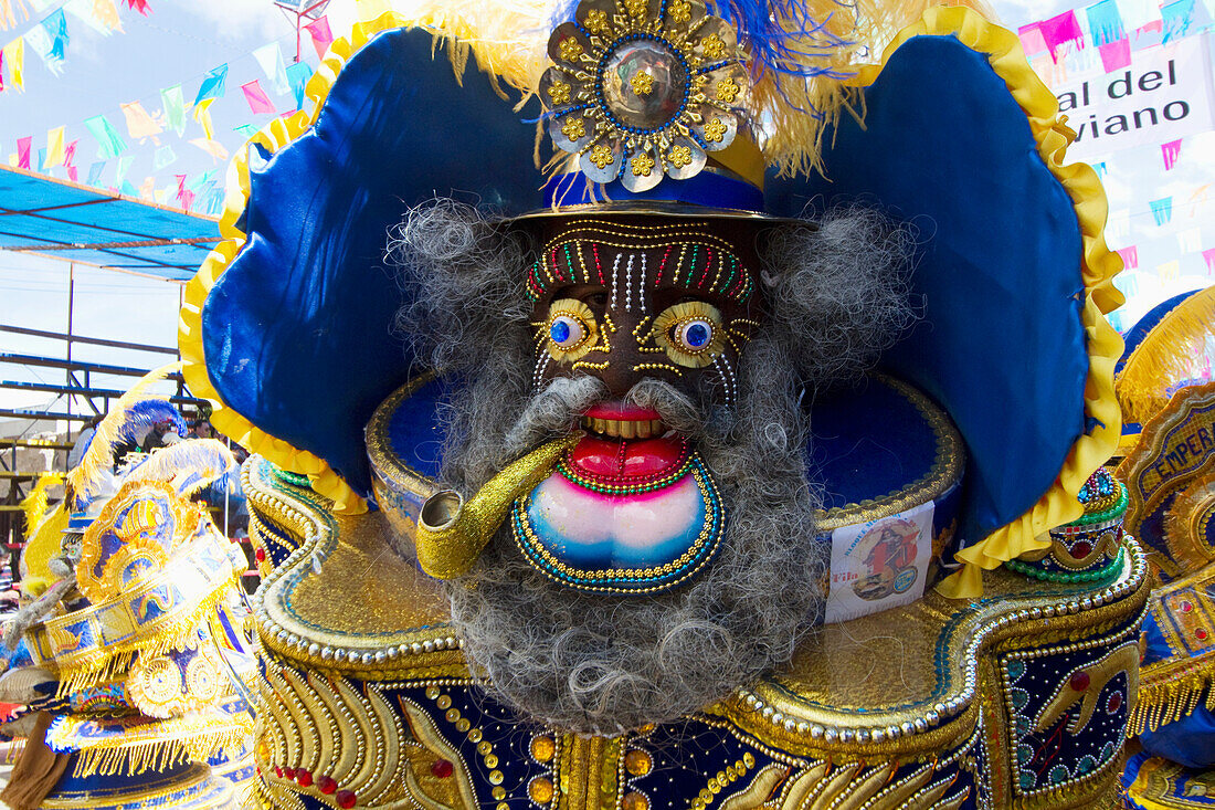 Morenada dancer wearing an elaborate mask and costume in the procession of the Carnaval de Oruro, Oruro, Bolivia