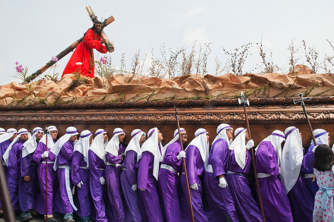 Men carrying the anda (float) of Jesus carrying the Cross during the Procession of the Holy Cross on Good Friday in Antigua Guatemala, SacatepÃ©quez, Guatemala