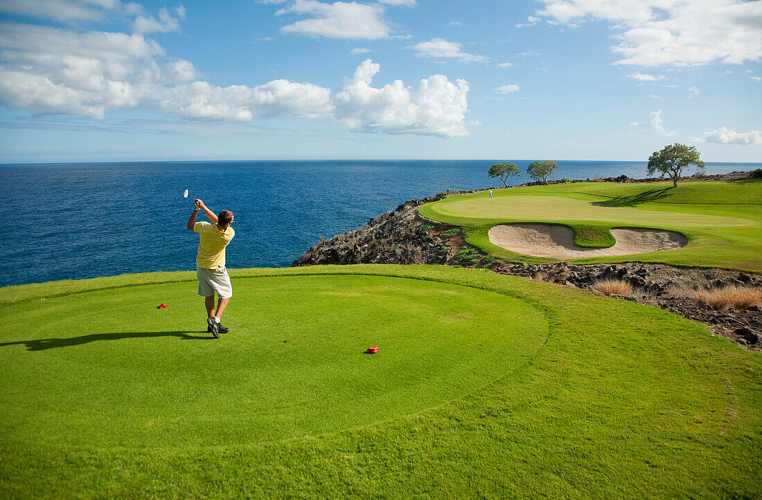 Hawaii, Lanai, Man playing golf at The Challenge at Manele Golf Course.