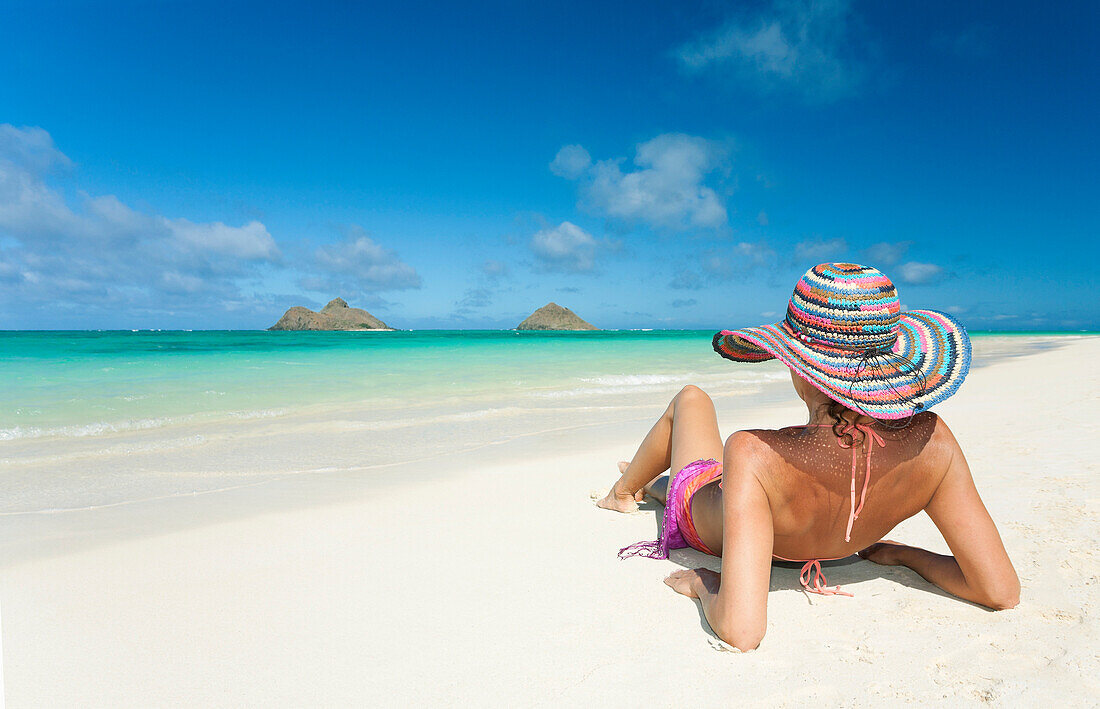 Hawaii, Oahu, Lanikai Beach, Woman relaxing along sandy shore.