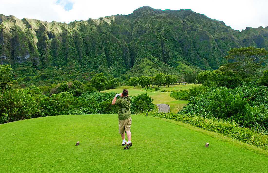 Hawaii, Oahu, Honolulu, Ko'olau Golf Course, Man drives at the fifth hole.