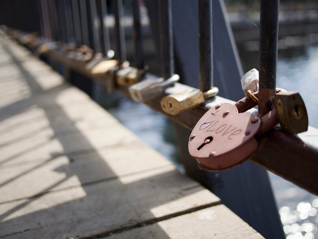 Locks left by romancing couples attached to bridge in accordance with local custom in Tampere, Finland