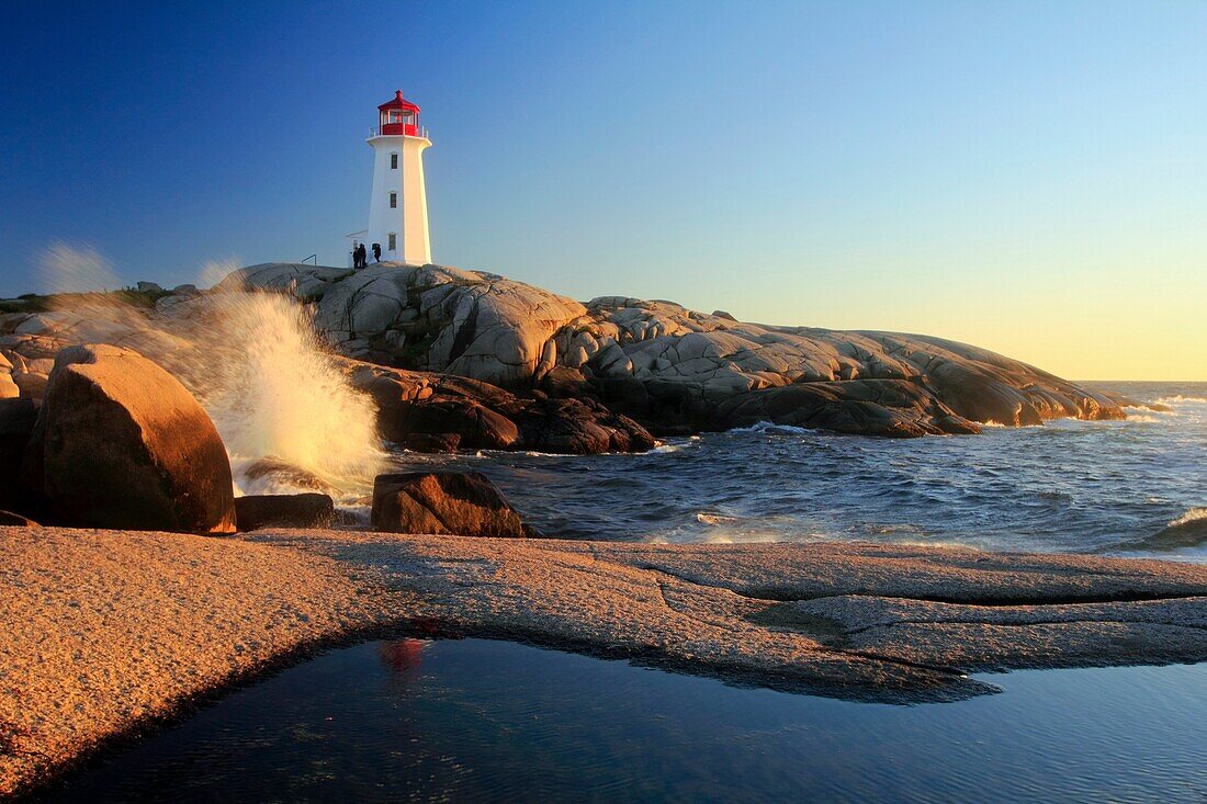waves crashing on rocks at Peggy´s Cove Lighthouse, Nova Scotia, Canada