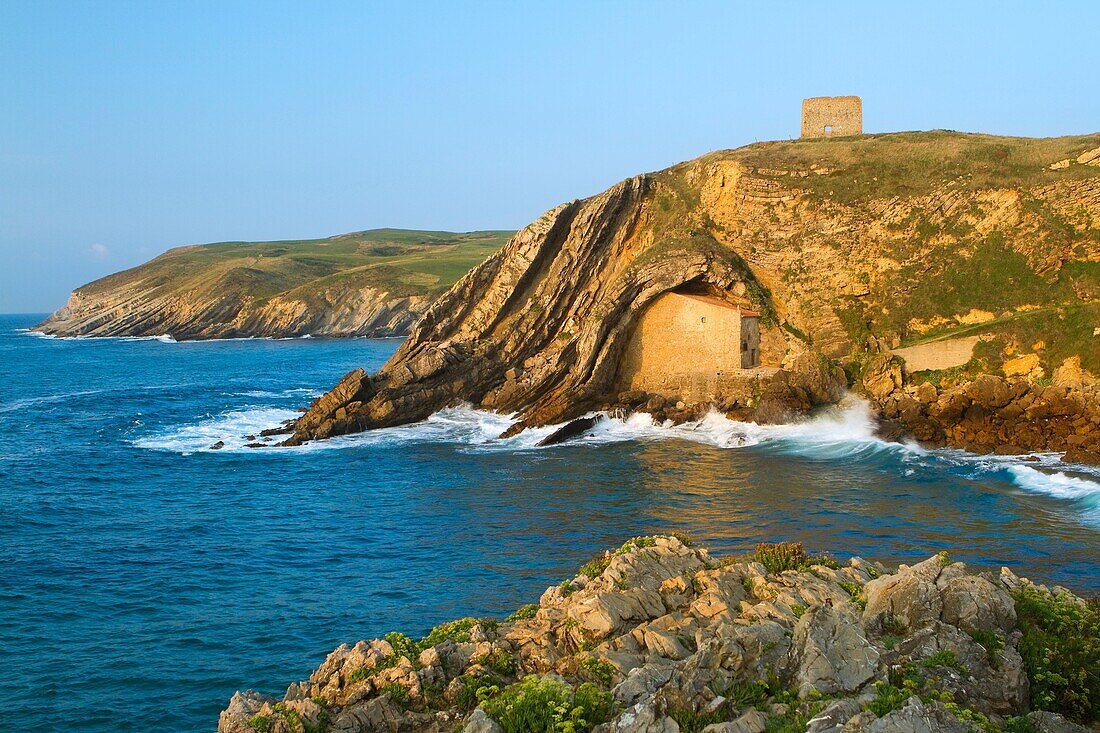 The small Santa Justa Chapel, embedded into the cliff  Santa Justa beach, Ubiarco village  Santillana del Mar  Cantabria  Spain