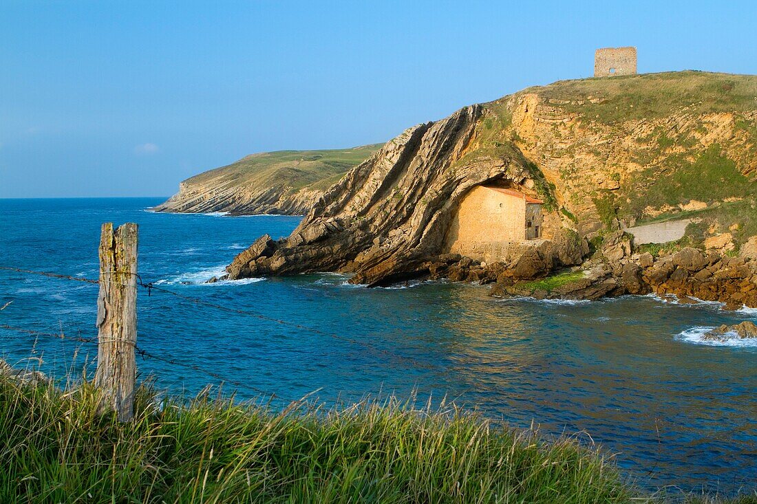 The small Santa Justa Chapel, embedded into the cliff  Santa Justa beach, Ubiarco village  Santillana del Mar  Cantabria  Spain