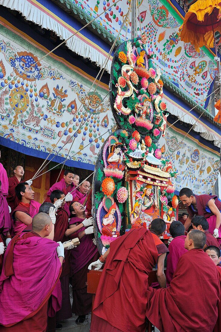China, Gansu, Amdo, Xiahe, Monastery of Labrang Labuleng Si, Losar New Year festival, Monks setting up skilfully carved yak butter sculptures