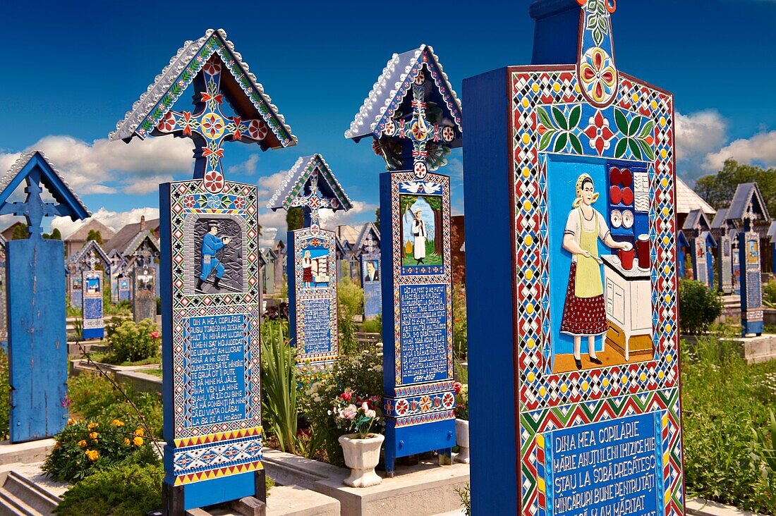 Tombstones in The Merry Cemetery  Cimitirul Vesel, Sapânta, Maramares, Northern Transylvania, Romania. The naive folk art style of the tombstones created by woodcarver Stan Ioan Patras 1909 - 1977 who created in his lifetime over 700 colourfully painted w