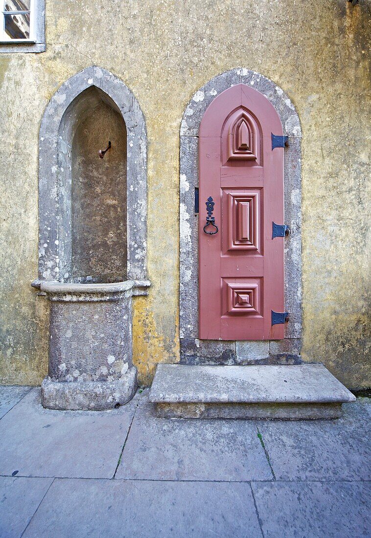 Red Carved Wood Door and a Water Fountain of the Fairytale Castle of Sintra