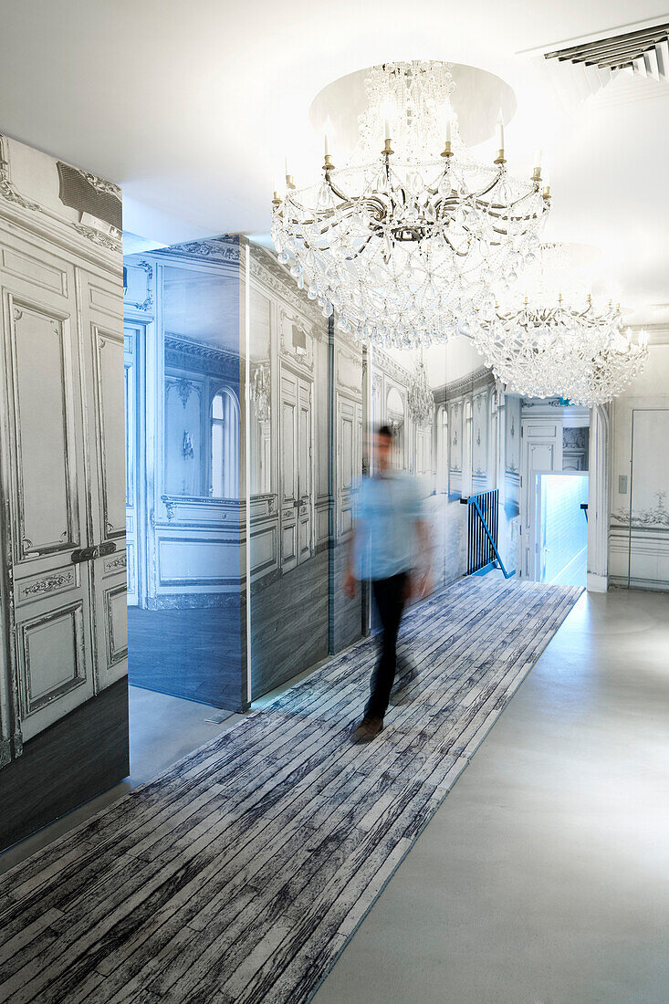 Man walking along a hotel corridor, Paris, France