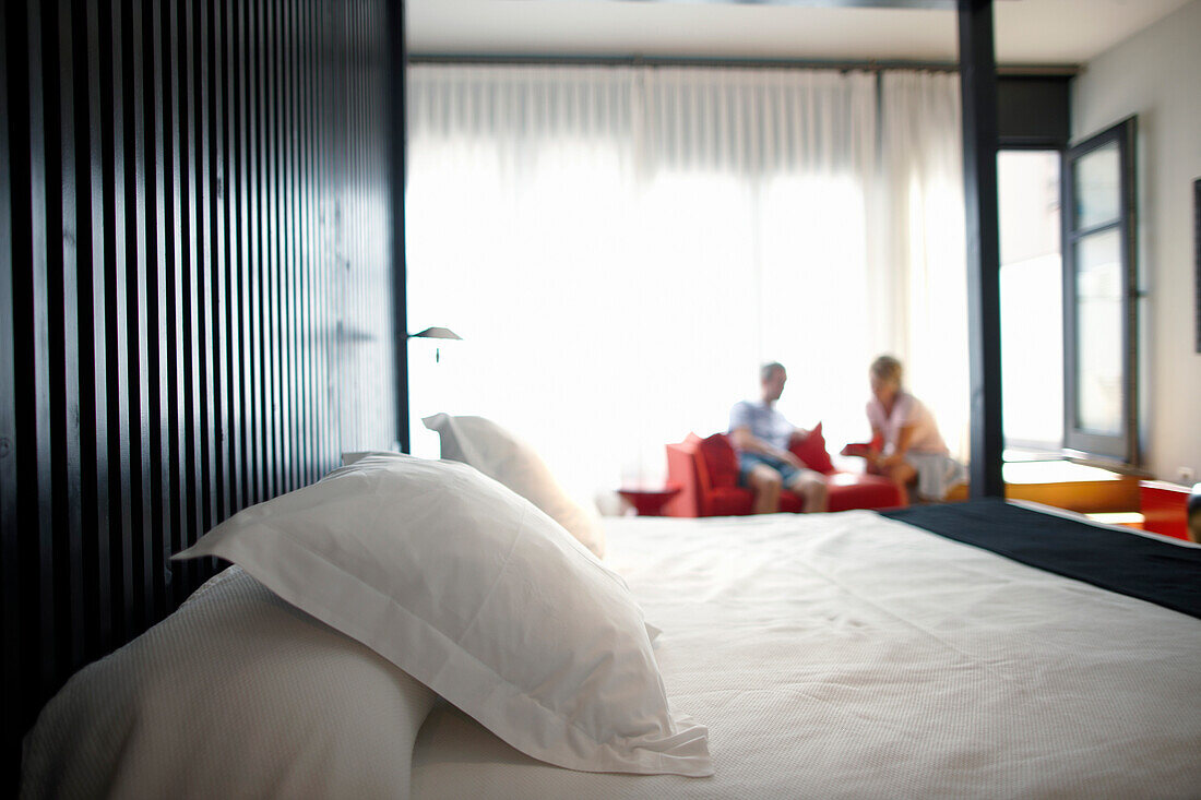 Couple sitting in a hotel suite, Barcelona, Catalonia, Spain