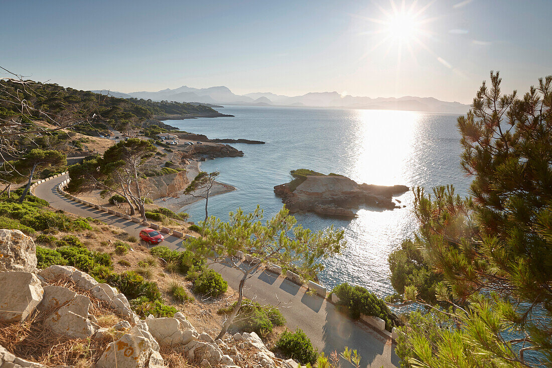 Coastal road leading to S'Illot chapel, view over Playa S'Illot beach, Alcudia peninsula, bay of Pollenca, Mallorca, Balearic Islands, Spain