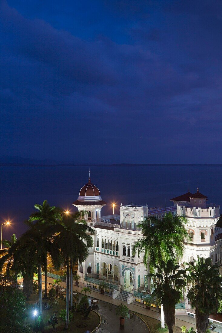 Cuba, Cienfuegos Province, Cienfuegos, Punta Gorda, Palacio de Valle, former sugar baron mansion, elevated view, dusk
