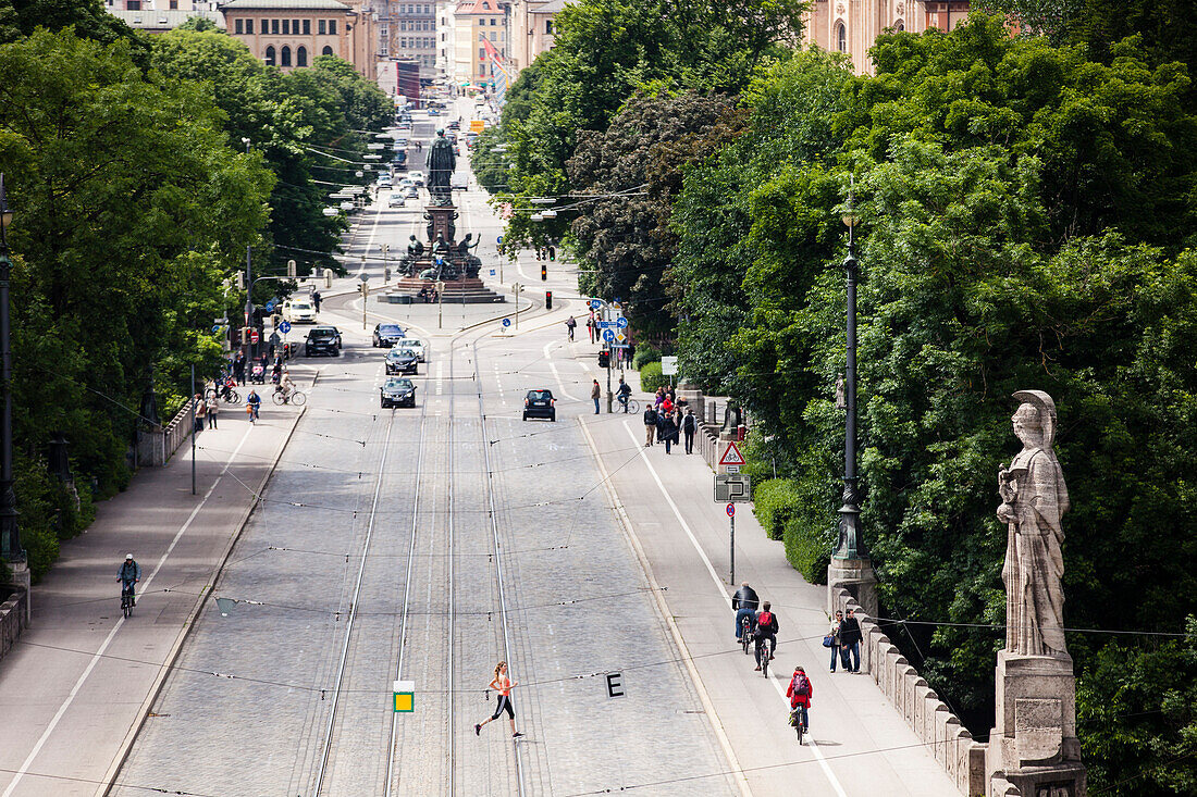 Young woman jogging over Maximilian bridge, Munich, Bavaria, Germany