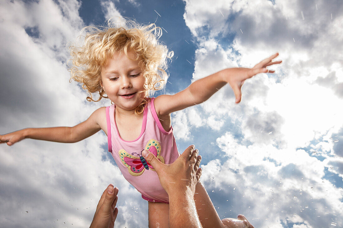 Girl in mid air, Lake Starnberg, Bavaria, Germany