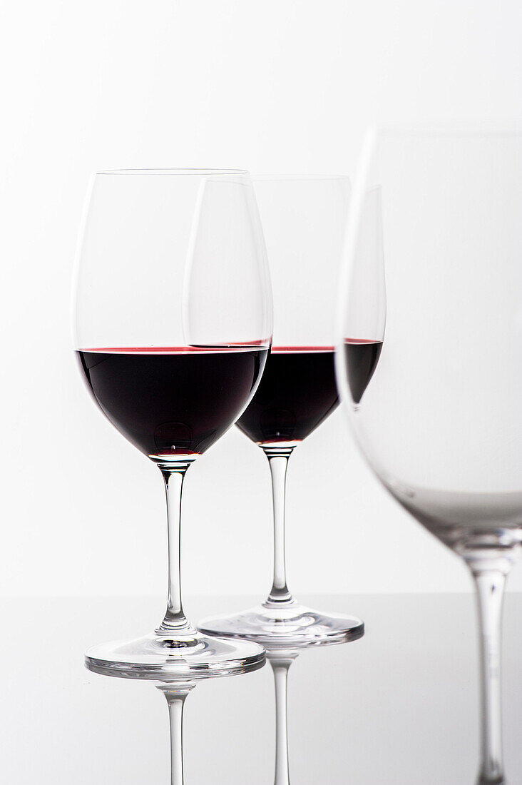 Two glasses of red wine and an empty glass, Hamburg, Northern Germany, Germany