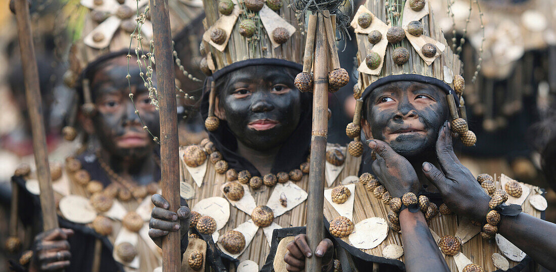 Three children with black smeared faces, Ati Atihan Festival, Kalibo, Aklan, Western Visayas Region, Panay Island, Philippines