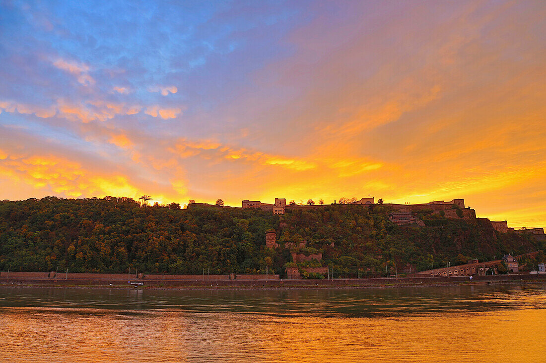 Fiery sunrise above Ehrenbreitstein fortress, Koblenz, Deutsches Eck, Confluence of Rhine and Mosel, Rhineland-Palatinate, Germany, Europe