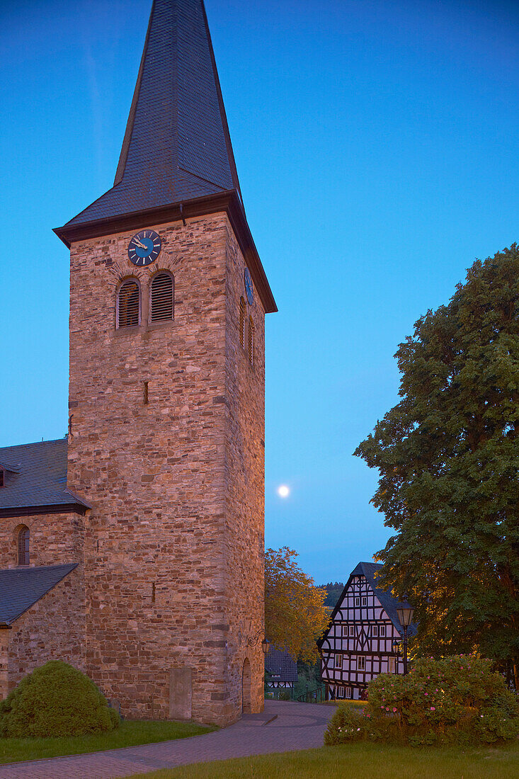 Church from about 1200 and half-timbered house and moon in Altenkirchen - Mehren, Westerwald, Rhineland-Palatinate, Germany, Europe