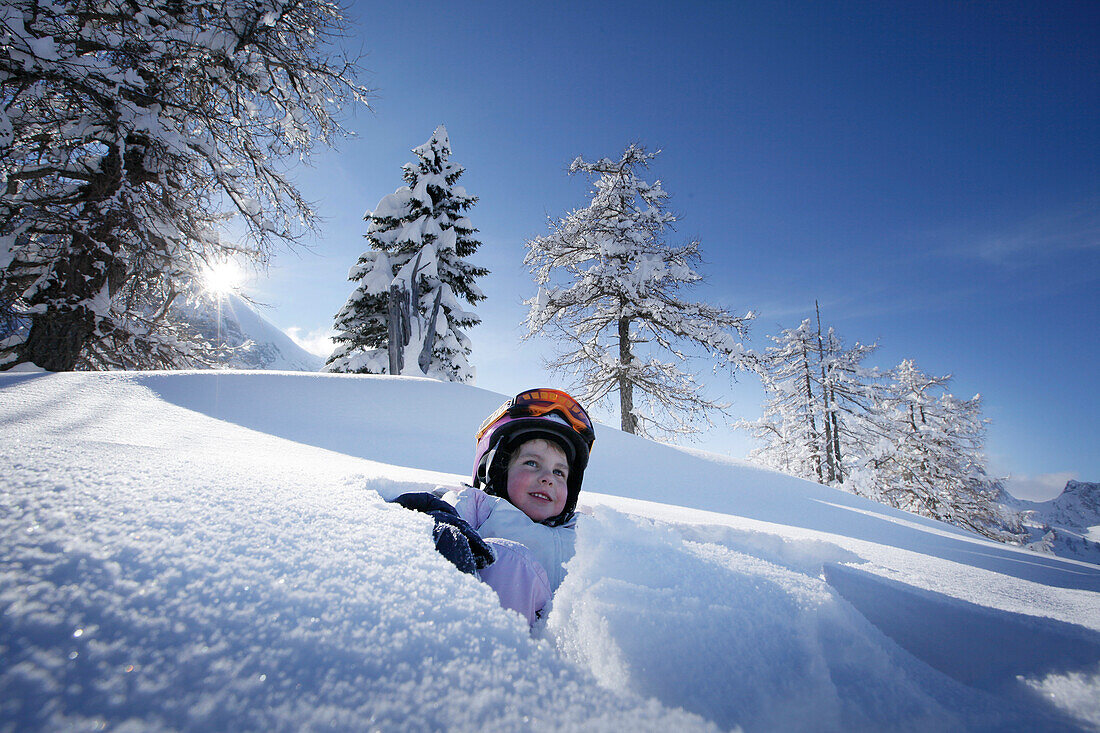 Girl (4 years) playing in snow, Hermagor, Carinthia, Austria