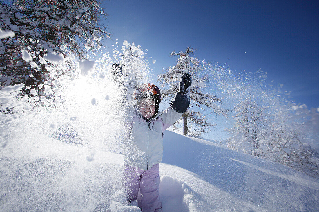 Girl (4 years) playing in snow, Hermagor, Carinthia, Austria