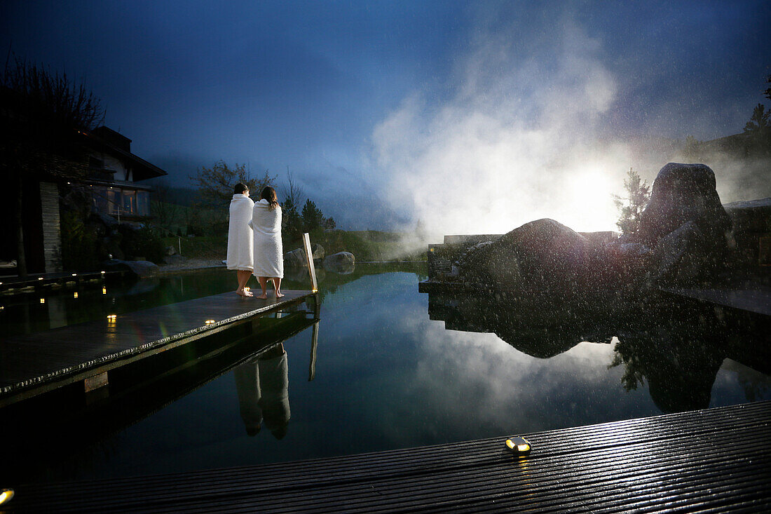 Hotel guests on a jetty at a natural source pond, Tannheim, Tannheim Valley, Tyrol, Austria