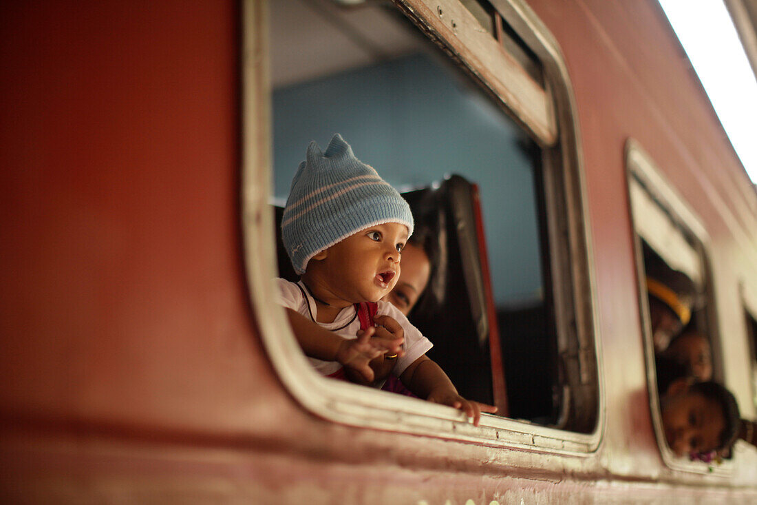 Passengers looking out of a train window, Ella, Badulla District, Uva Province, Sri Lanka