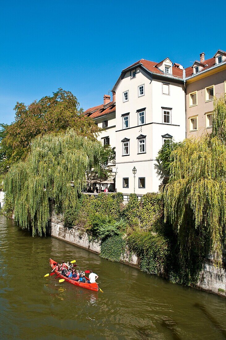 Children canoeing on River Ljubljanica, Old town, Ljubljana, Slovenia