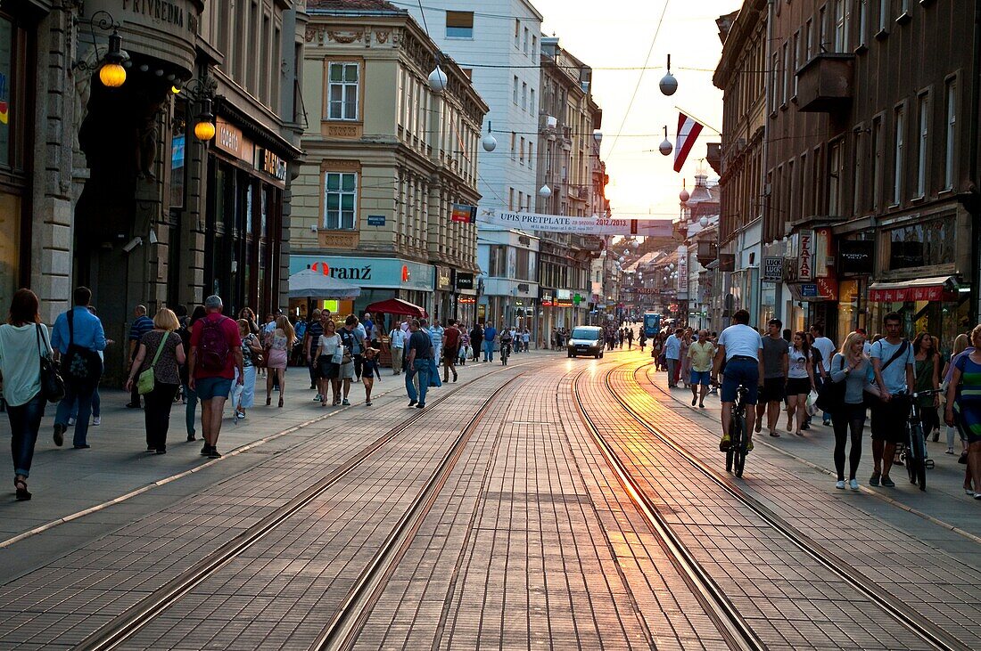 Tramlines and cobbled pavement on Ilica street reflecting late sunshine, Zagreb, Croatia