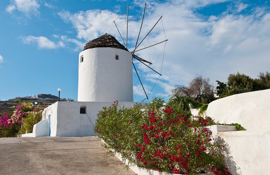 White windmill house in town in valley of Fira in Santorina Greece in Greek Islands