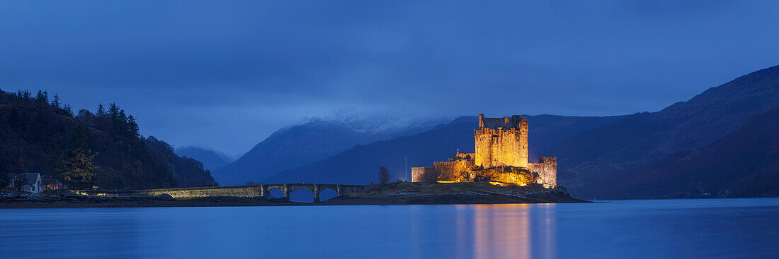 Panorama of the medieval Eilean Donan Castle in Loch Duich with mountains in the background, Dornie, Scotland, United Kingdom