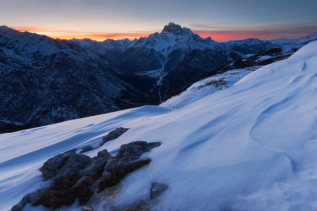 Sunset with snow structures on the plateau of Monte Piano, looking west to the Dolomiti di Braies, Sexten Dolomites, South Tyrol, Italy