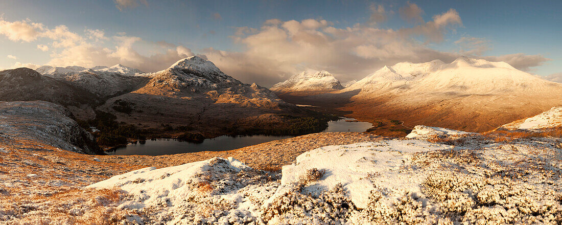 Vast panorama of the snow-covered North West Highlands overlooking the summits of Sgurr Dubh, Liathach and Beinn Eighe (from left) over the Loch Clair in winter, Scotland, United Kingdom