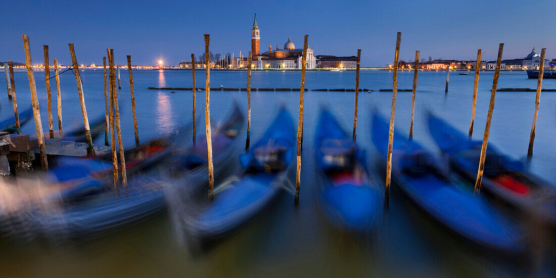 View from Piazza San Marco to wavering Gondolas on the Grand Canal and the island of San Giorgio Maggiore at dusk, Venice, Veneto, Italy