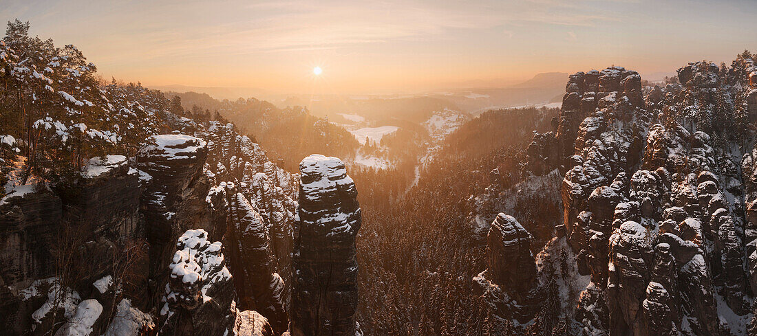Sunset above the Saxon Switzerland national park with the wide view above the Raaber Kessel in winter, Saxony, Germany
