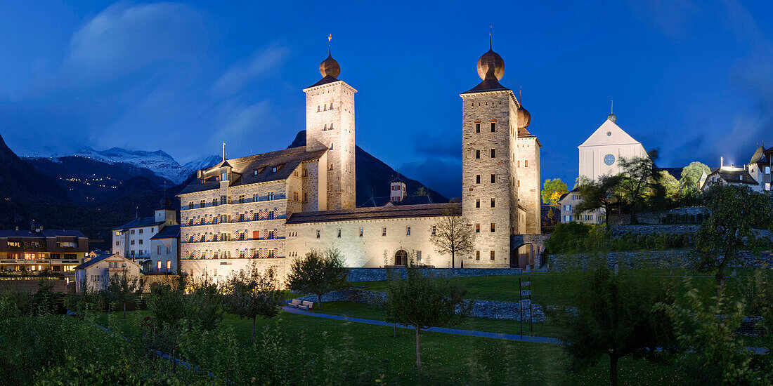 Dusk over the Stockalper palace in Brig with snowy mountains in the background, Valais, Switzerland