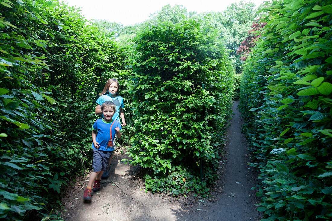 Two children running through the labyrinth, Altjessnitz, Raguhn-Jessnitz, Saxony-Anhalt, Germany