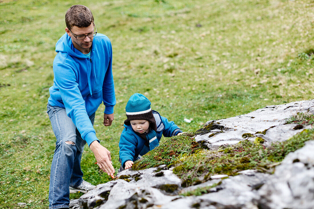 Father and son (2 years) on a meadow, near Maria Alm, Pinzgau, Salzburg, Austria