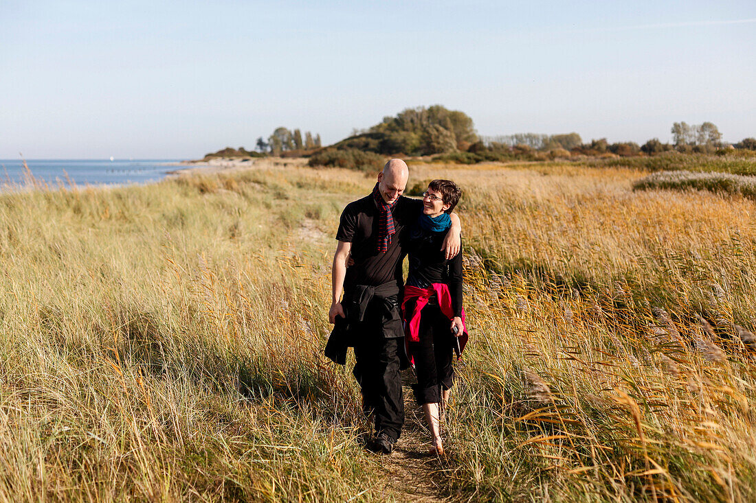 Young couple strolling along beach, Kagsdorf, Bastorf, Mecklenburg-Western Pomerania, Germany