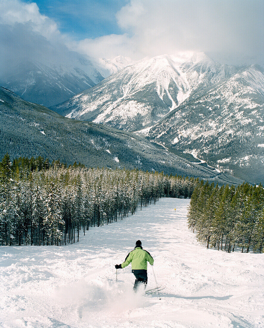 CANADA, person skiing with snow covered mountain in background, Panorama