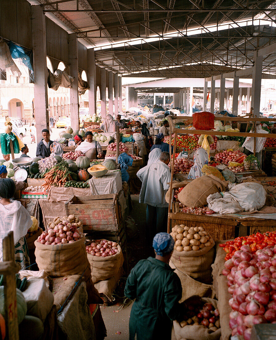 ERITREA, Asmara, people sell and buy produce at an open market in Asmara