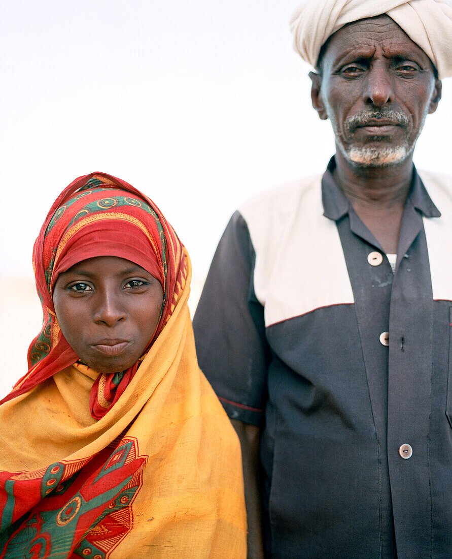 ERITREA, Saroita, portrait of an Afar Mr. Bedri and his daughter in front of their home in the small village of Saroita