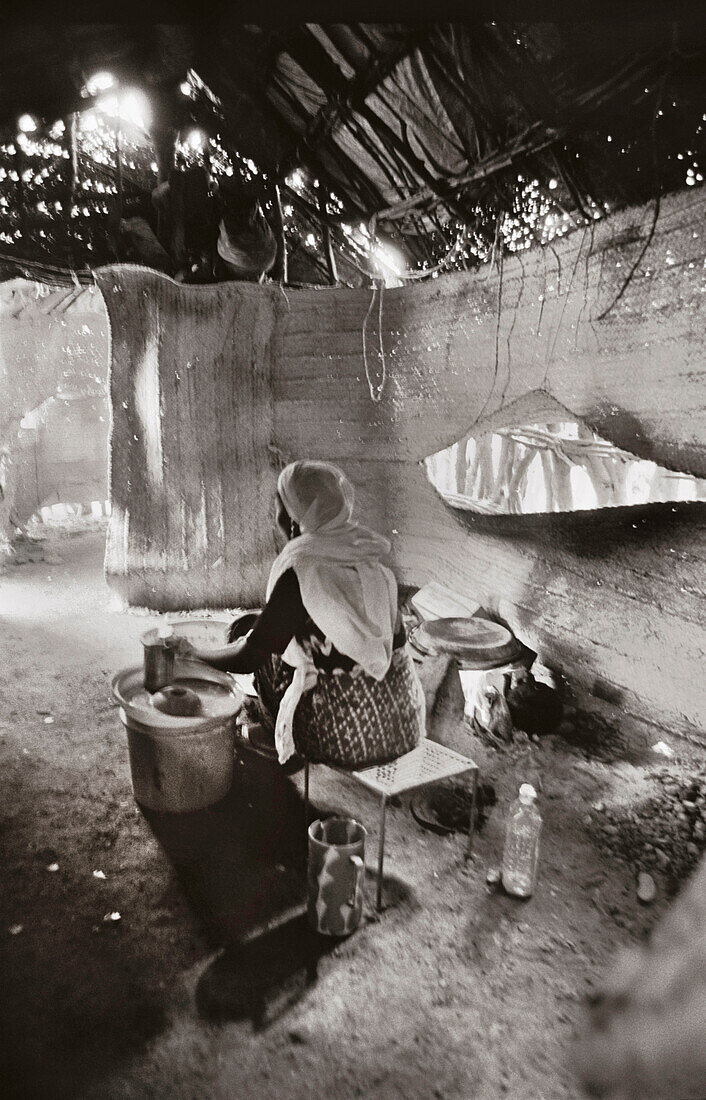 ERITREA, Galallo, a woman makes injera bread at a small roadside restaurant called Ali’s (B&W)