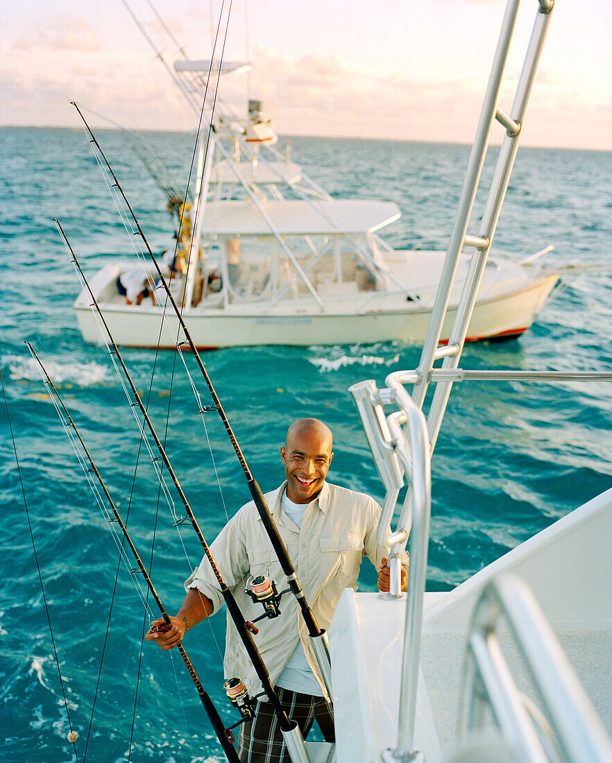 USA, Florida, mid adult man smiling on fishing boat at sea, portrait, Islamorada
