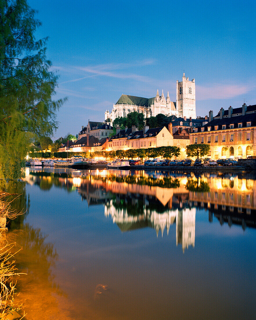 FRANCE, Burgundy, Abaye Saint Germain reflecting on river at night, Auxerre