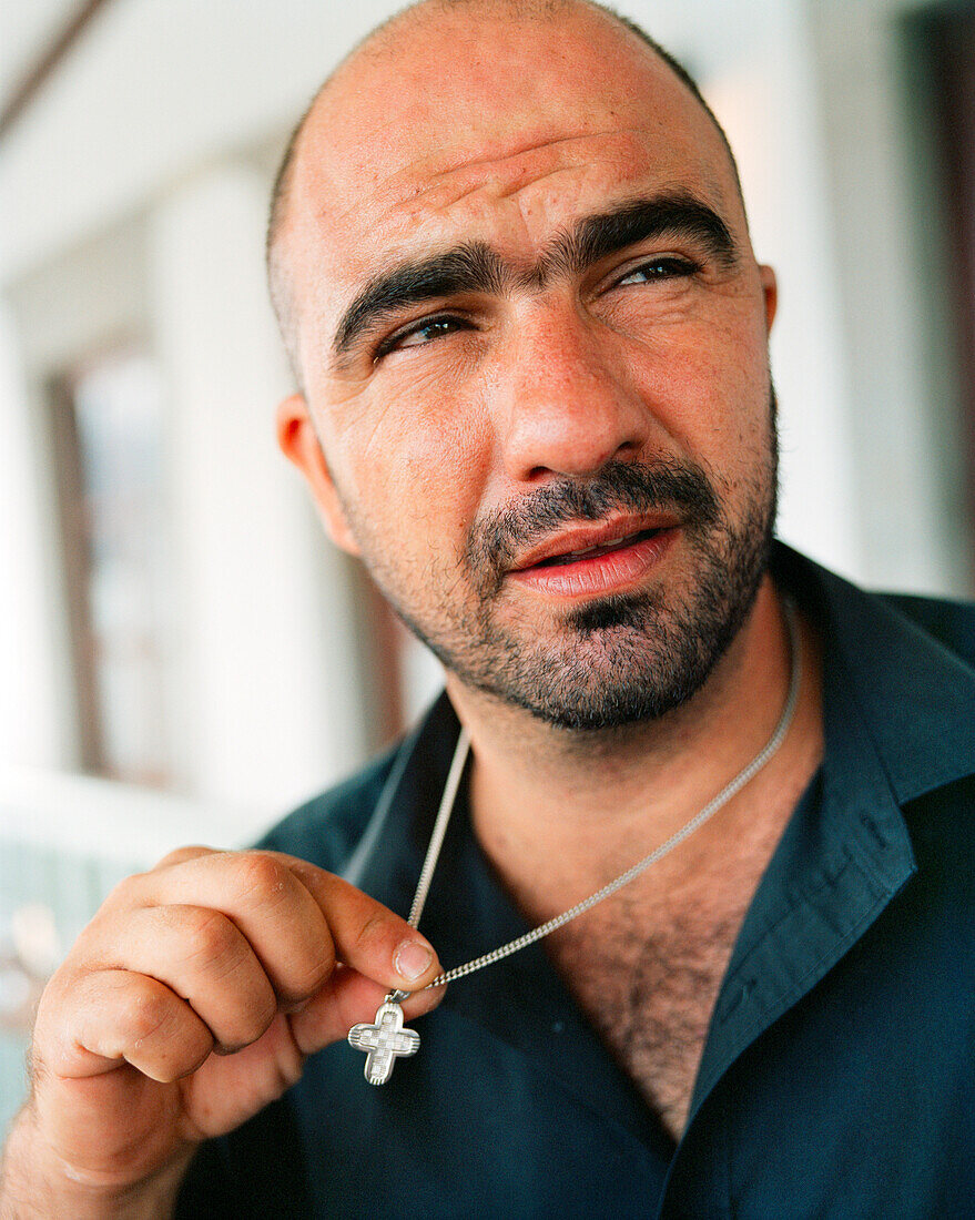 GREECE, Patmos, Skala, Dodecanese Island, taverna owner and musician Yannis Kaneli at his restaurant, Taverna Tzivaeri